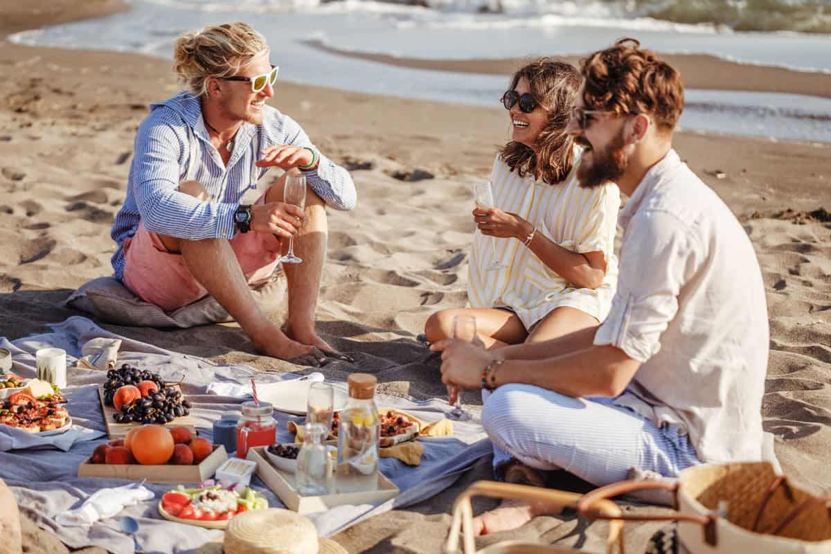 Young people enjoying a picnic on the beach.