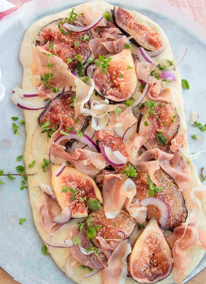 Figs and Prosciutto laid out of focaccia dough. 