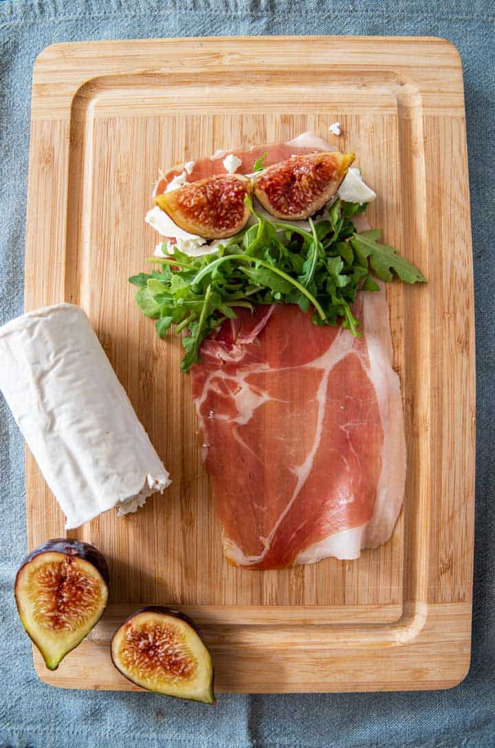 Ingredients laid for prosciutto rolled figs with goats cheese.
