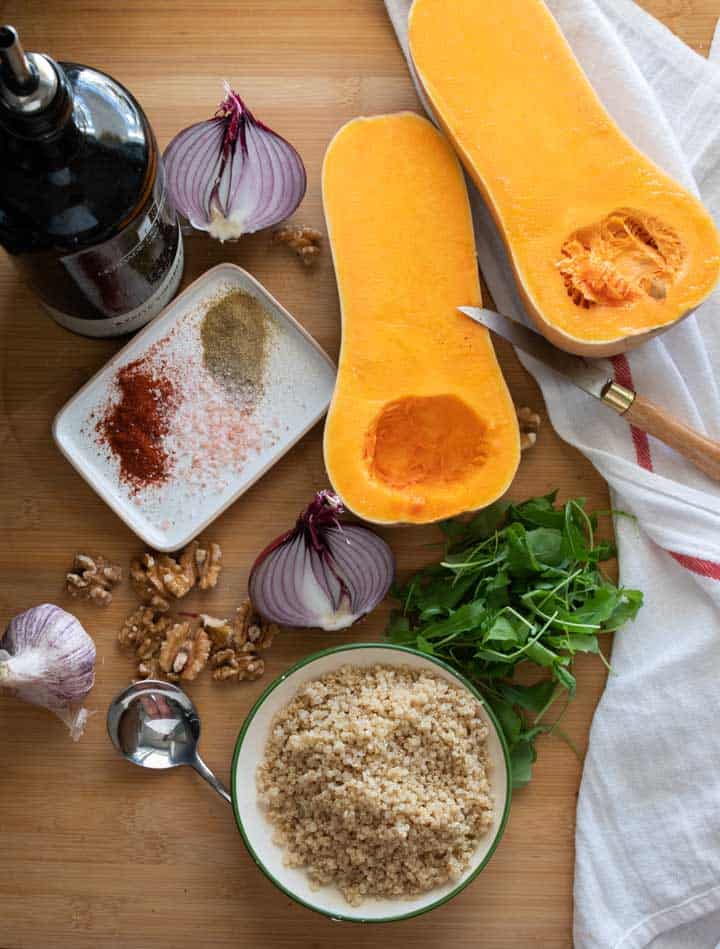 Ingredients laid out for spiced pumpkin and quinoa salad. 