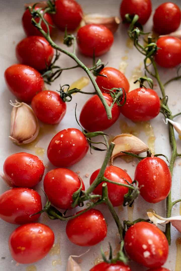 Vine tomatoes and fresh garlic cloves drizzled with olive oil and salt. 