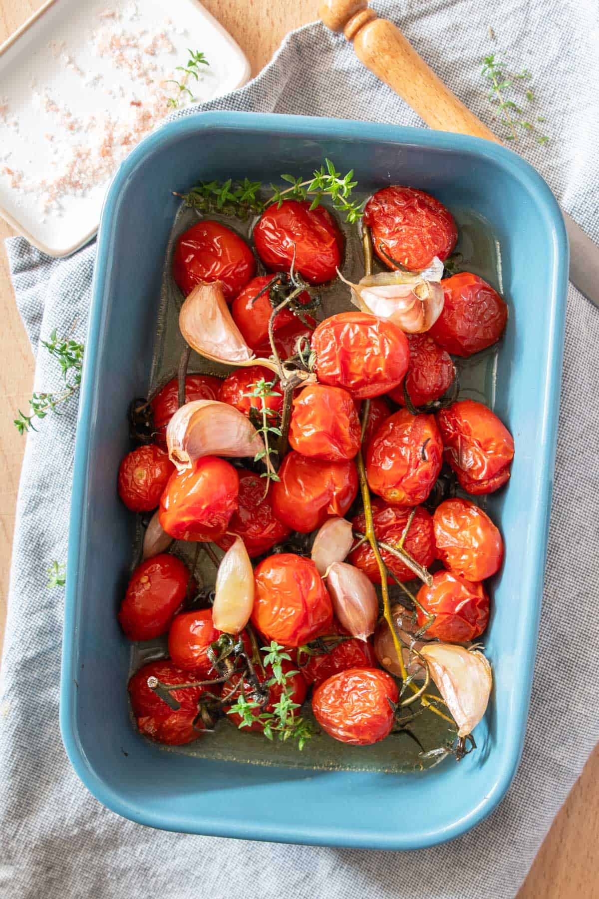 A bowl of roasted tomatoes and garlic.