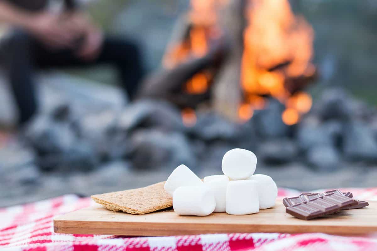 Marshmallows and chocolate in front of bonfire. 