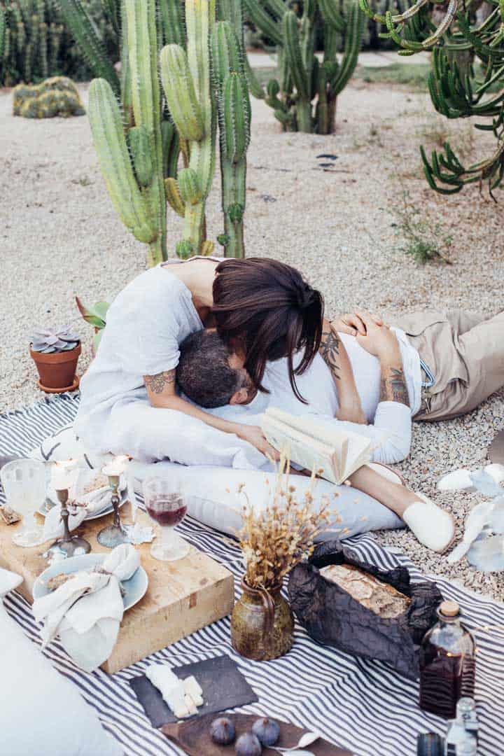 Young couple kissing at a romantic picnic
