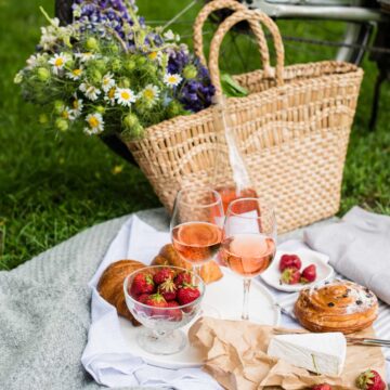 A spring picnic with flowers in a basket leaning against a bicycle.