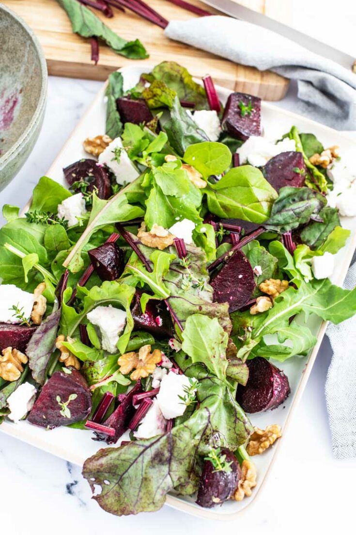 Colourful roasted beet salad with fresh greens, feta and walnuts.