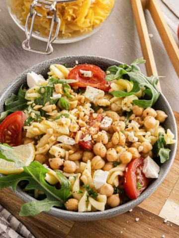 Chickpea Pasta Salad surrounded by fresh ingredients.