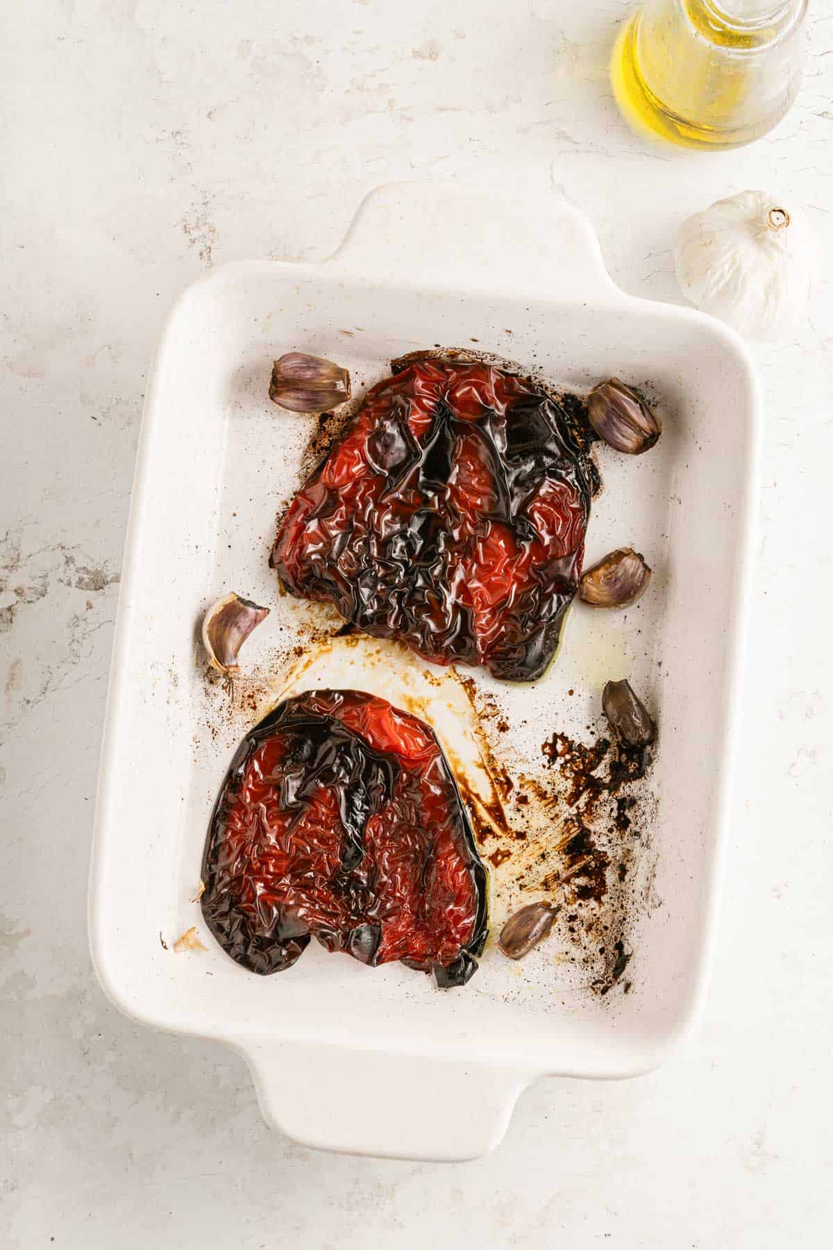 Roasted red peppers in a baking dish.