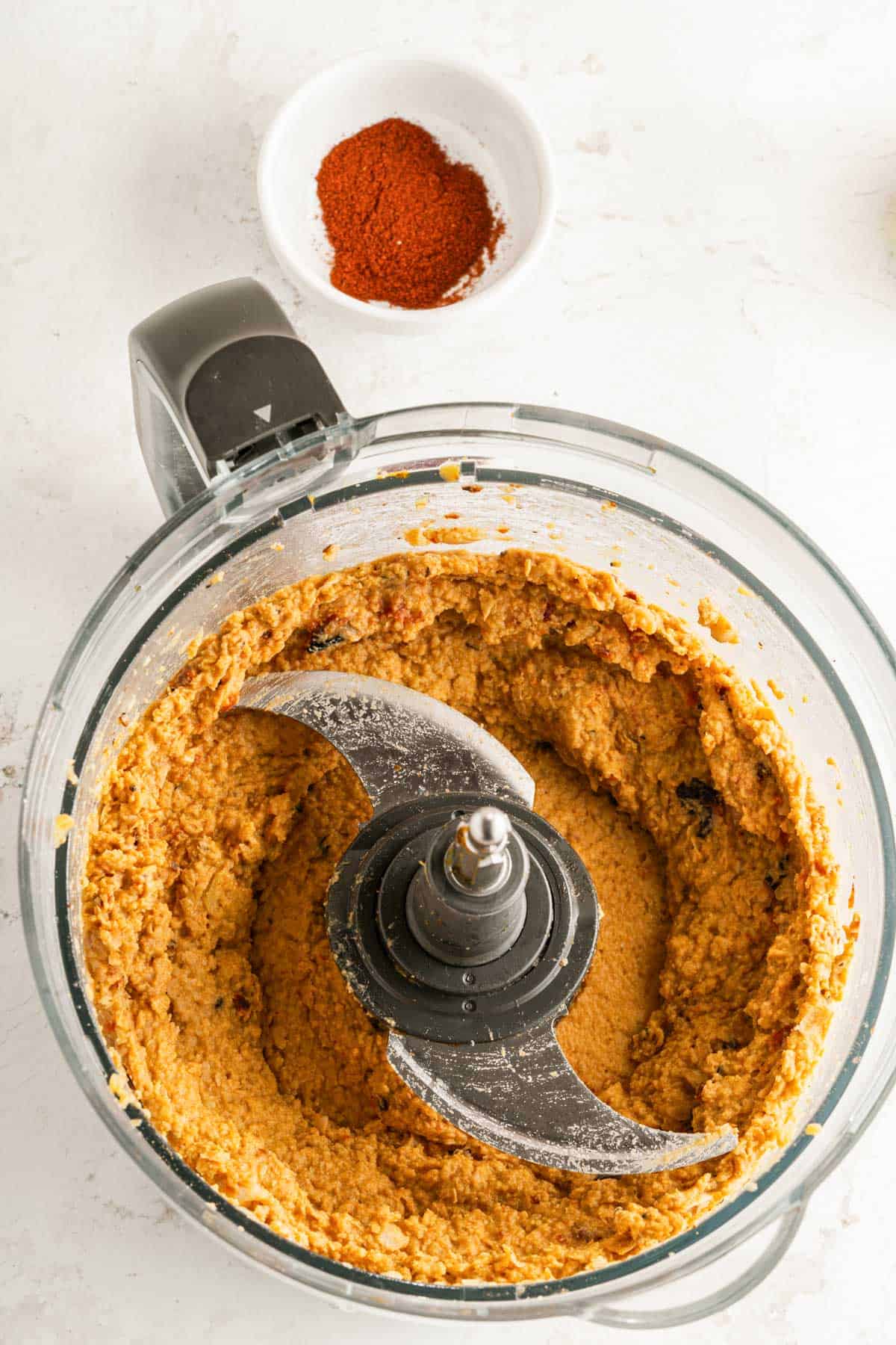 Blended roasted red pepper hummus in a food processor.