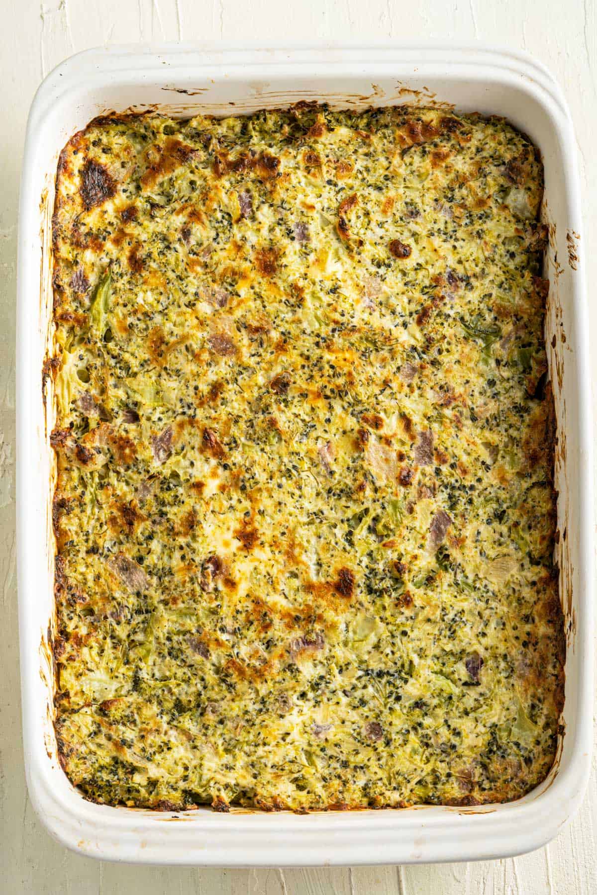Baking tray filled with hot broccoli cheese dip.