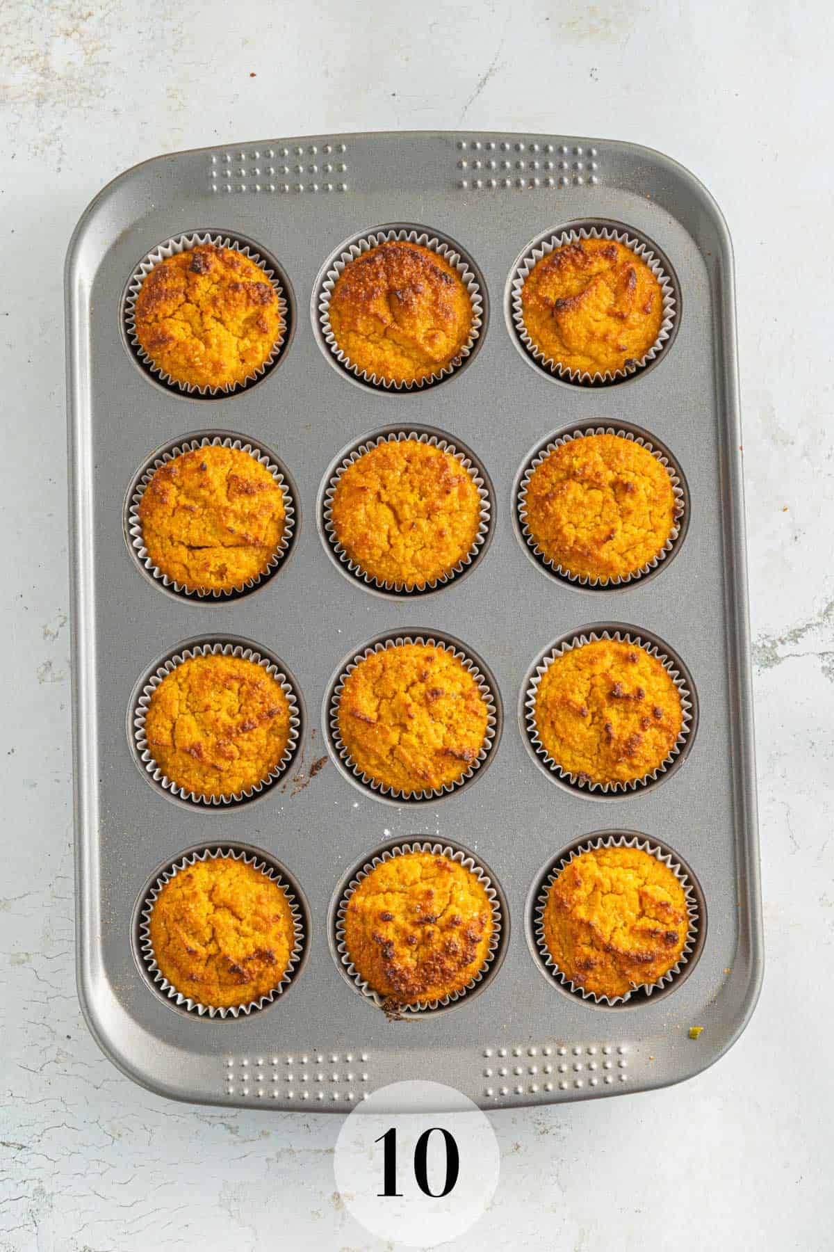 A tray of freshly baked pumpkin muffins in a muffin tin.