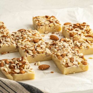Slices of white chocolate fudge with almonds on top.