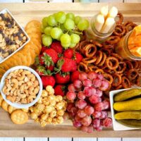 Serving board with healthy kid friendly snacks for a picnic.