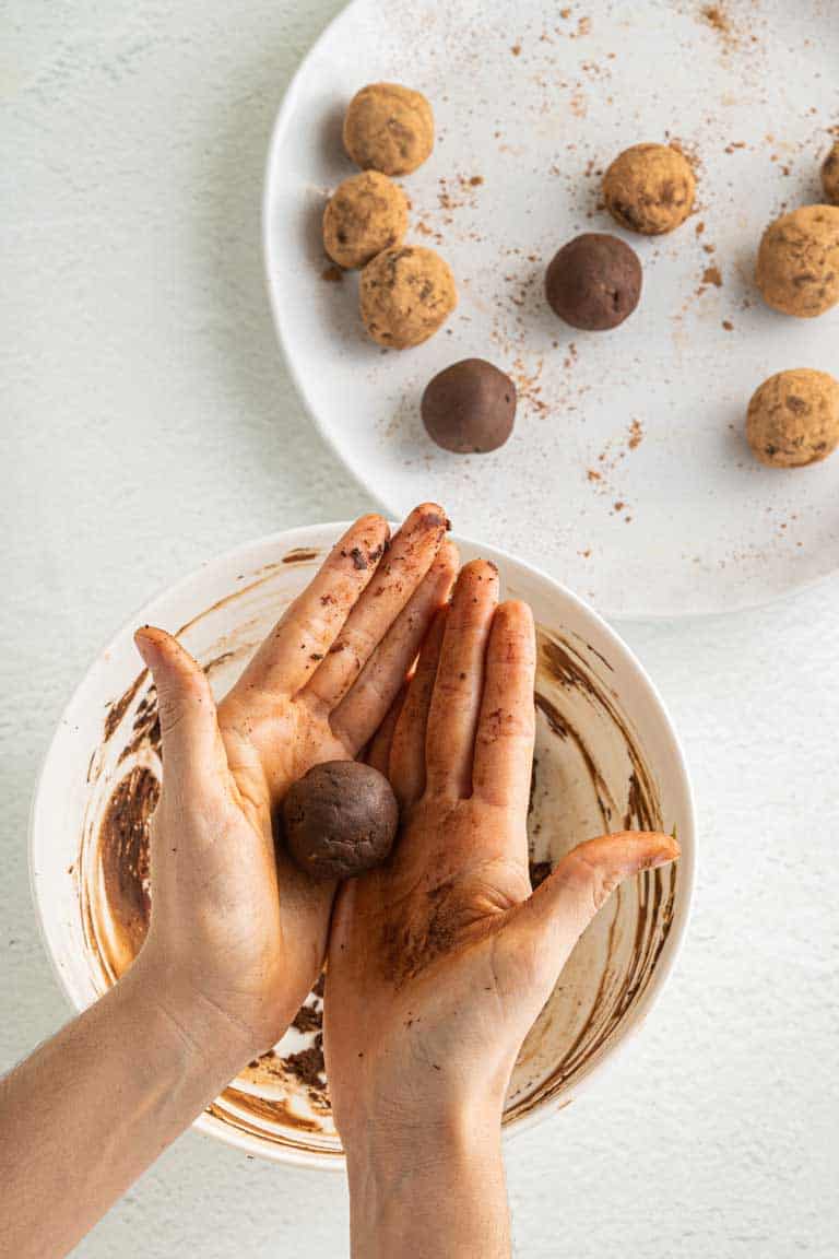 Rolling chocolate avocado mix into truffle balls.