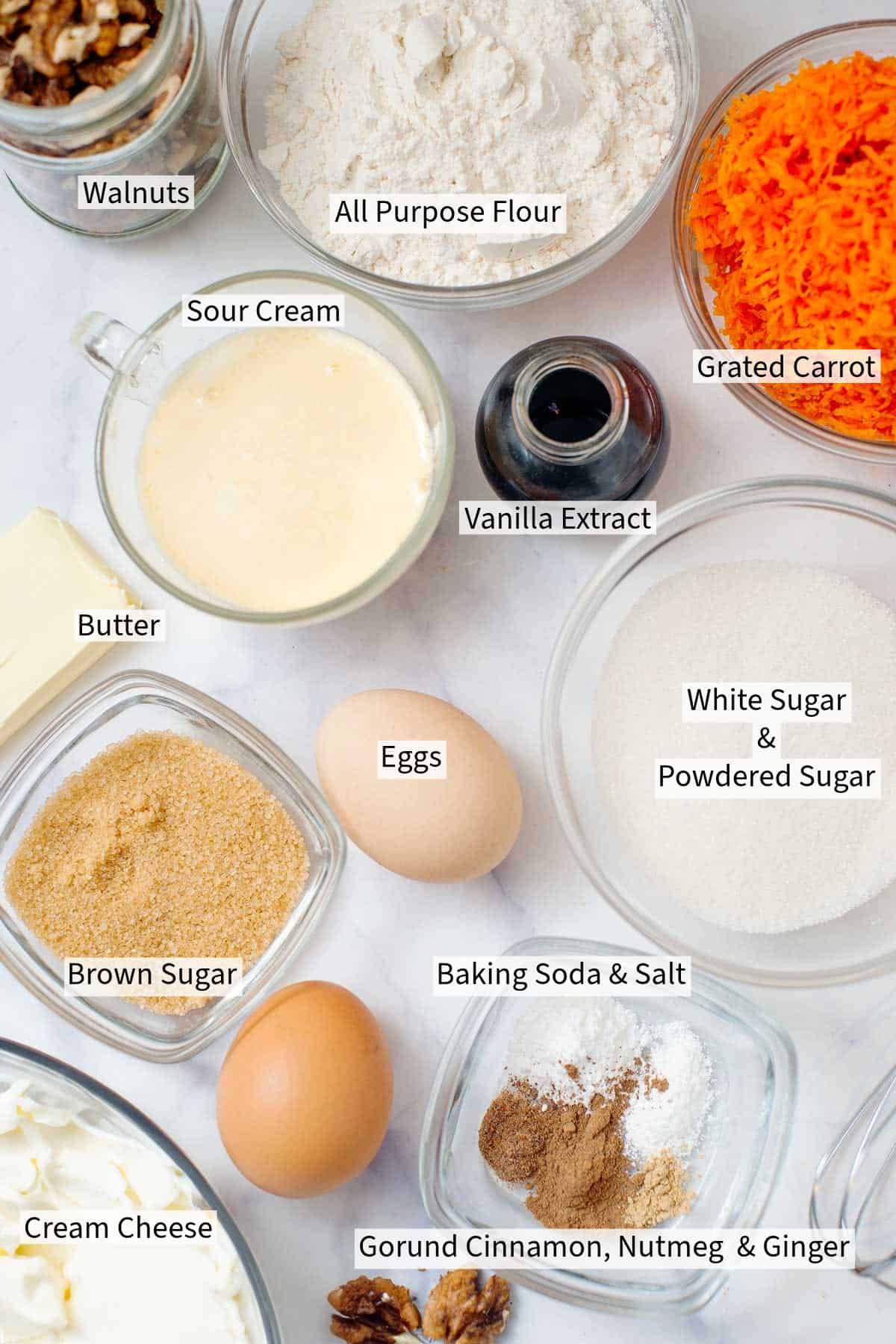 Ingredients for Carrot Cupcakes on a white table. 