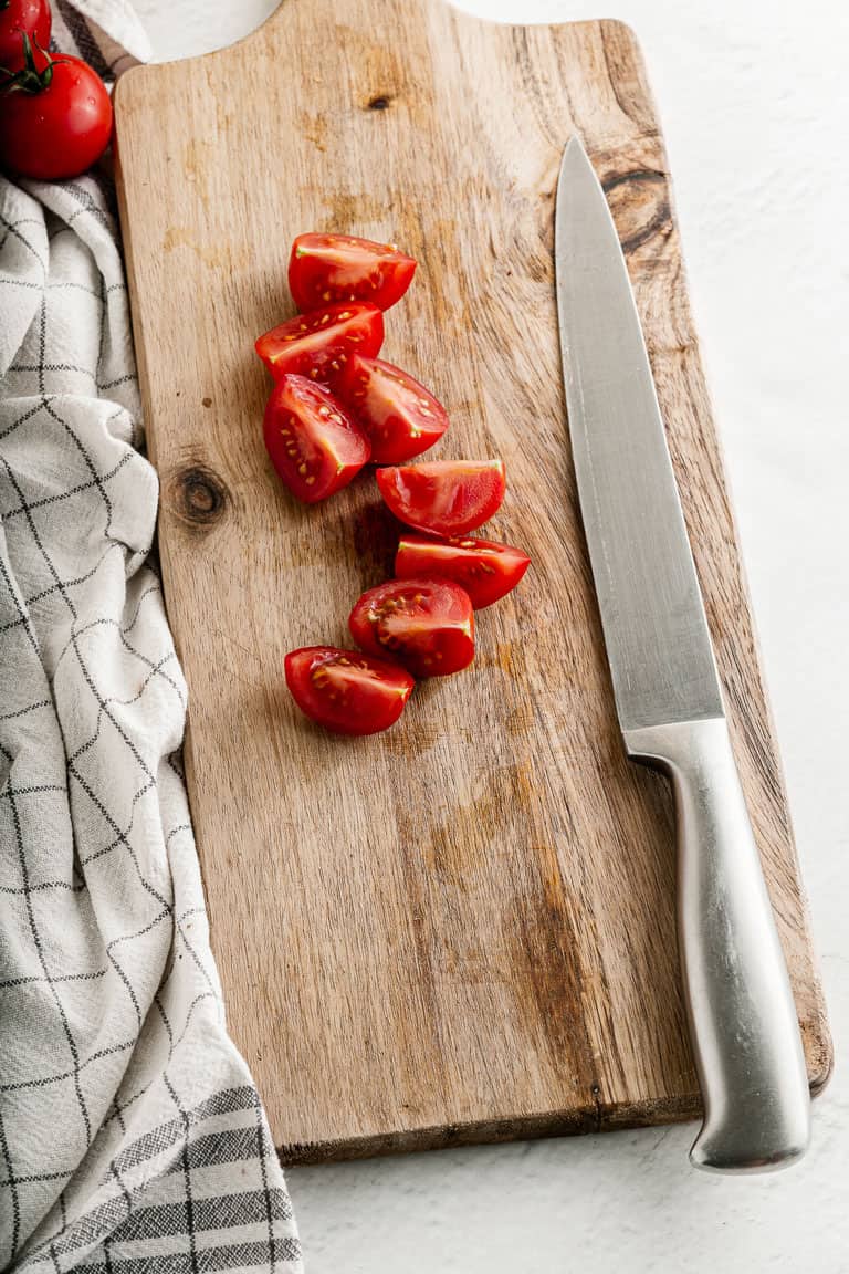 Chopped tomatoes on a chopping board.