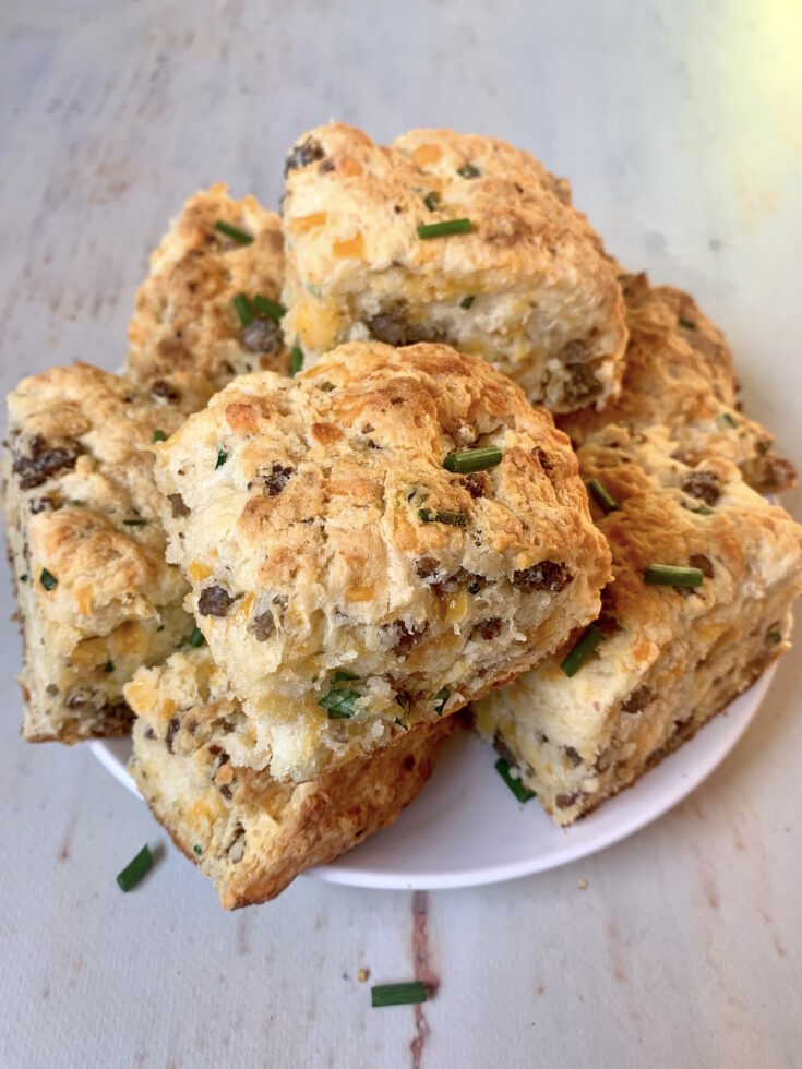 https://picniclifestyle.com/wp-content/uploads/2022/01/Plate-of-Sausage-Cheddar-Biscuits-735x980.jpg