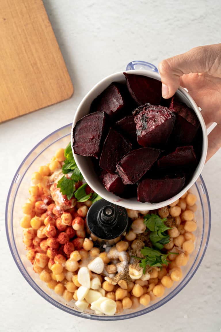 Prepare a delicious beet hummus by combining beets and chickpeas in a food processor.
