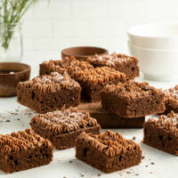 Squares of Keto chocolate cake displayed on a bench.