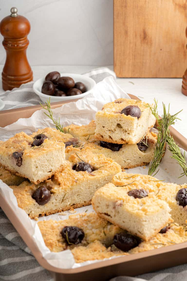 Slices of keto focaccia bread with olives and rosemary.
