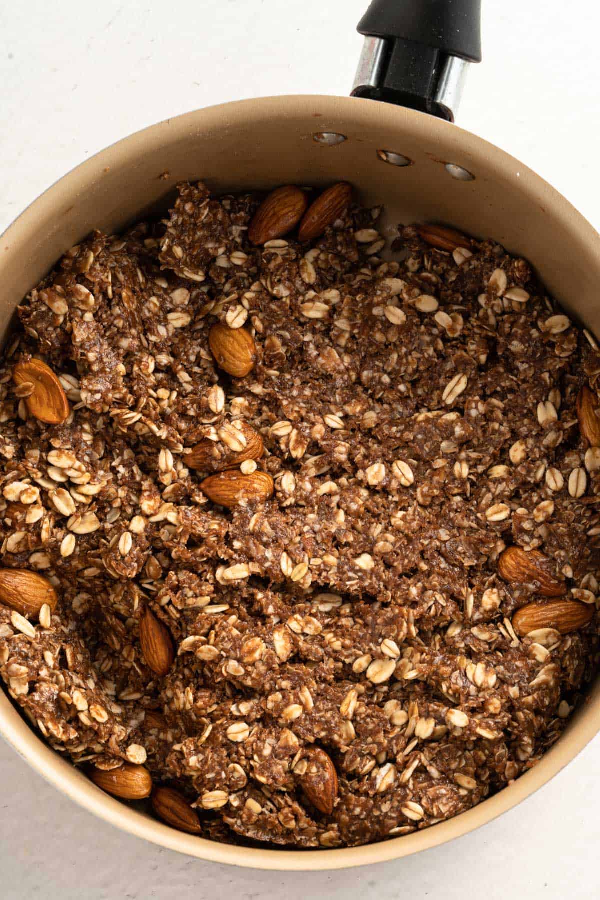 The final mix of a no bake chocolate oat bar recipe in a saucepan.