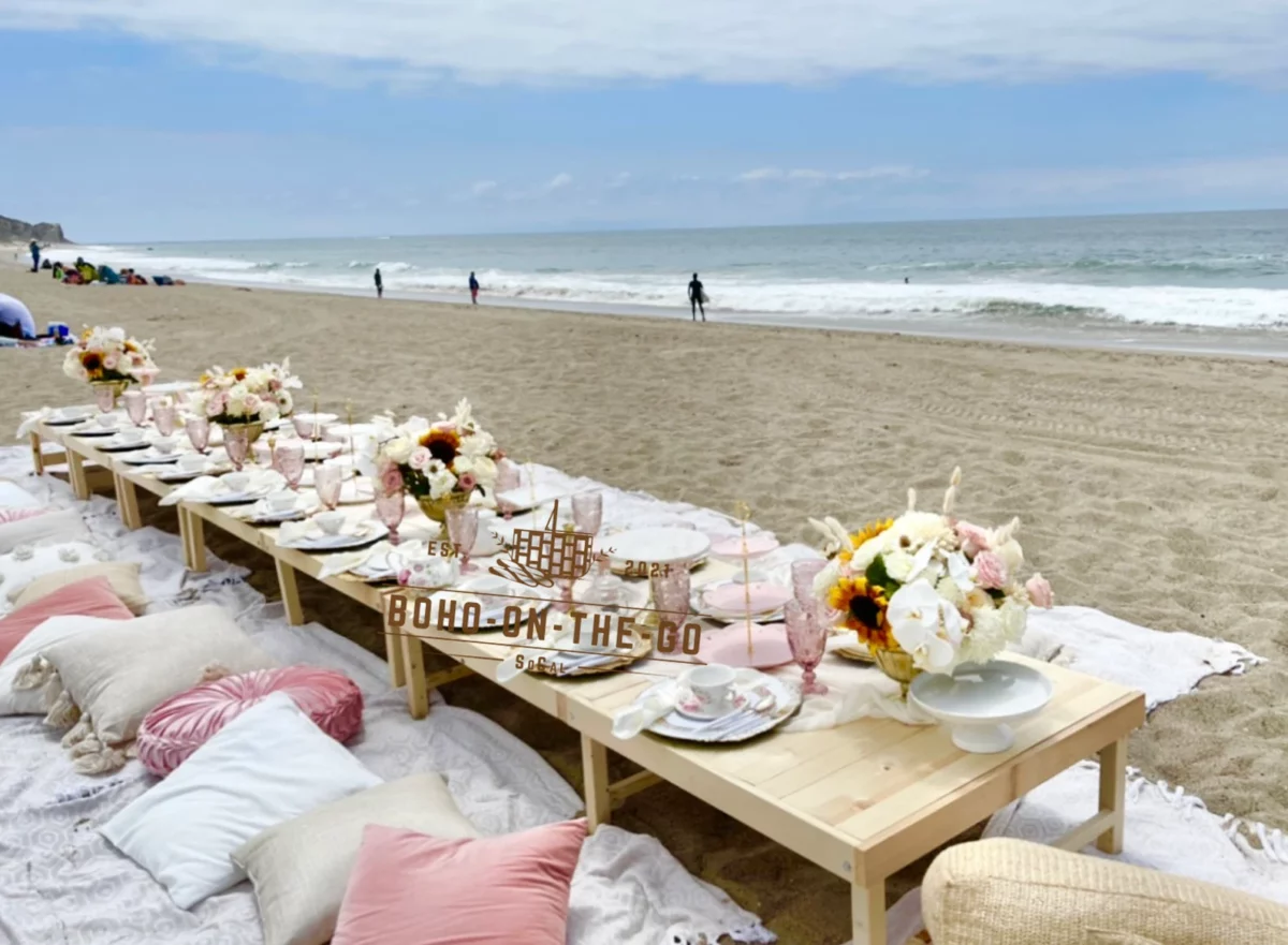 Boho picnic setting on a beach for a picnic party. 