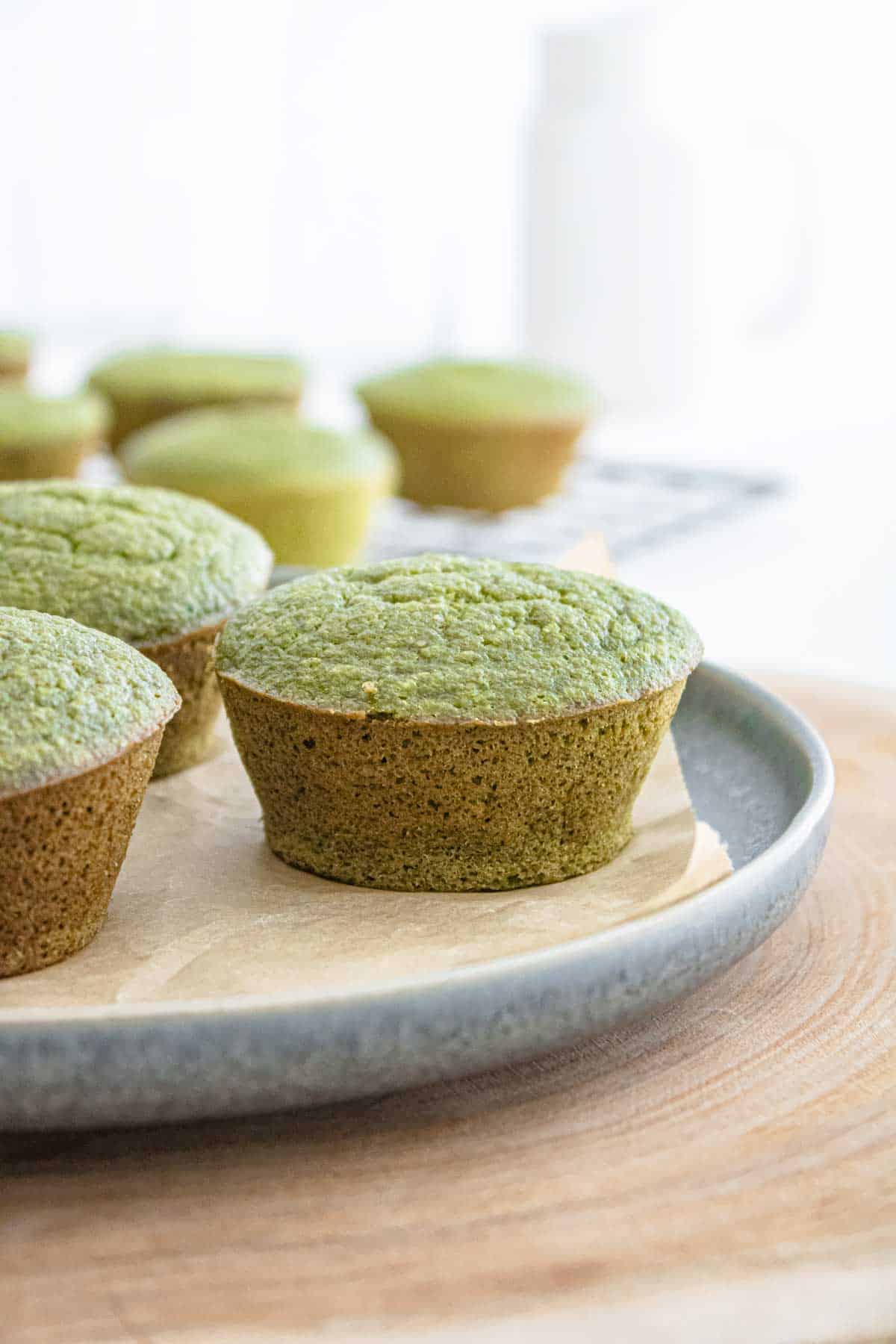 Green spinach and banana muffins on a plate.