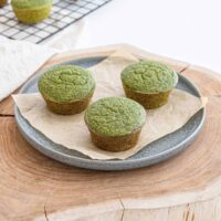 Green banana and spinach muffins on a plate.