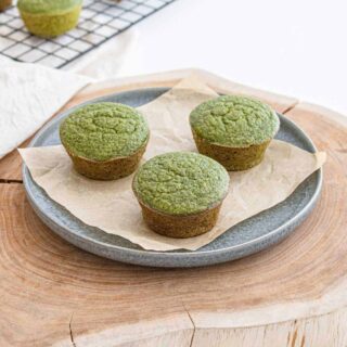 Green banana and spinach muffins on a plate.