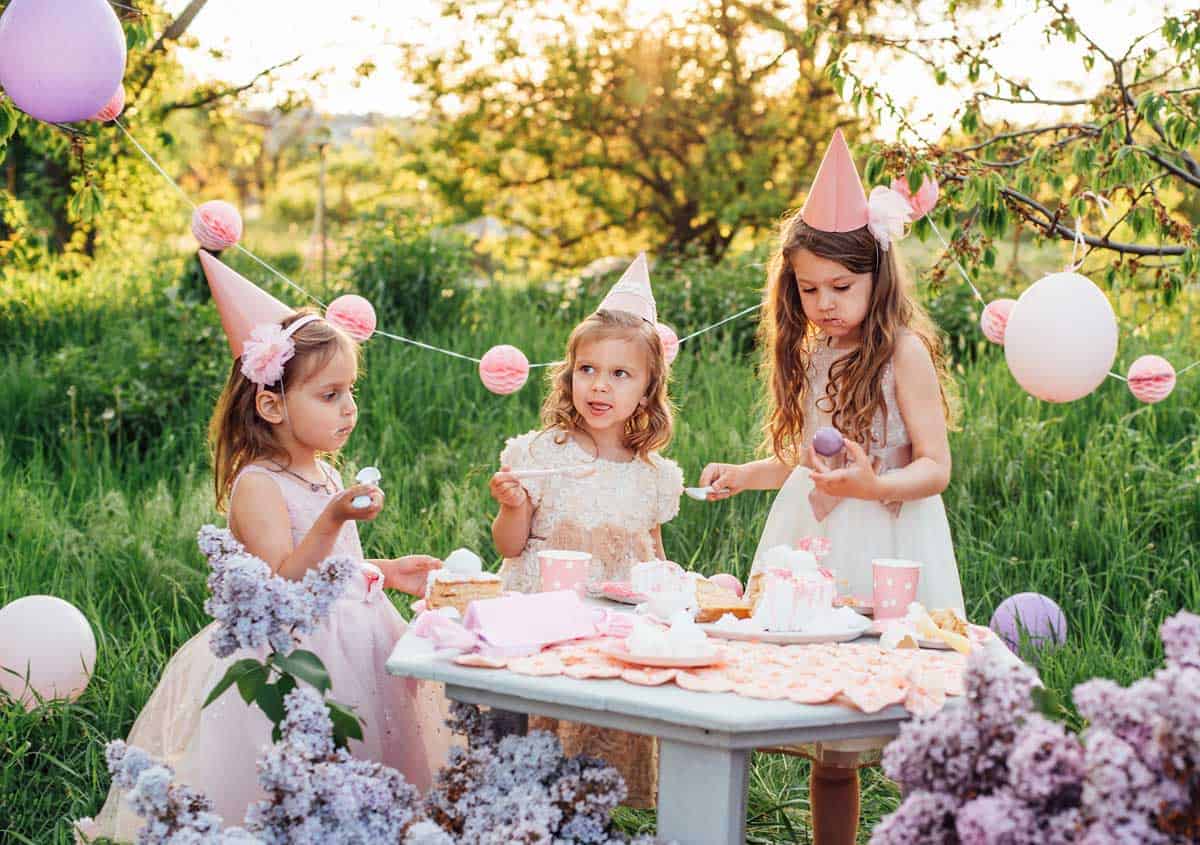 Young girls enjoying a pink themed birthday picnic. 