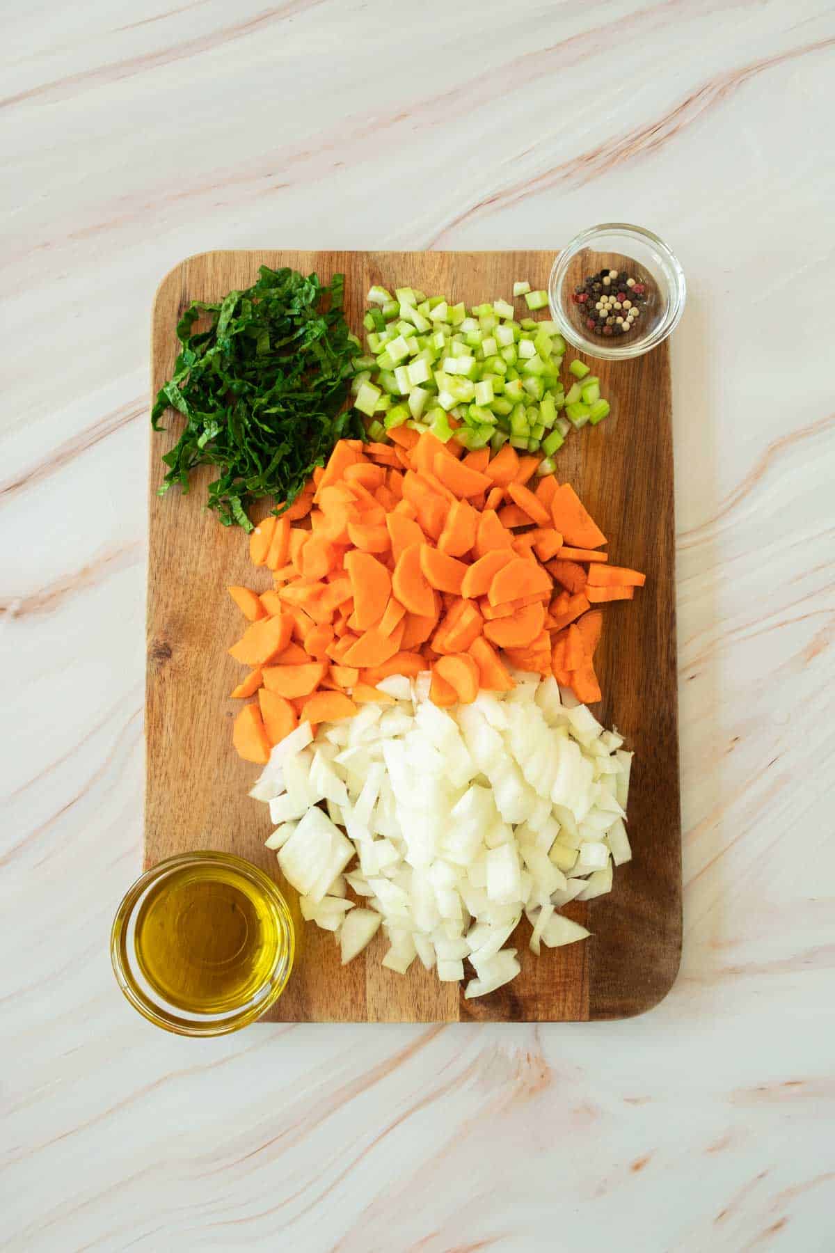 Carrots,celery and onions on a cutting board for chicken soup.