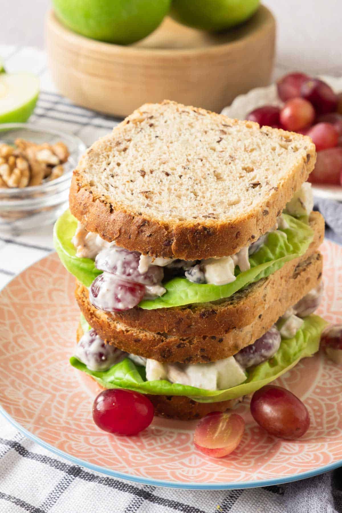 A sandwich with lettuce, grapes and grapes on a plate.