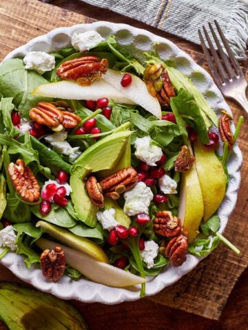 A winter salad with pears, pecans and pomegranate.