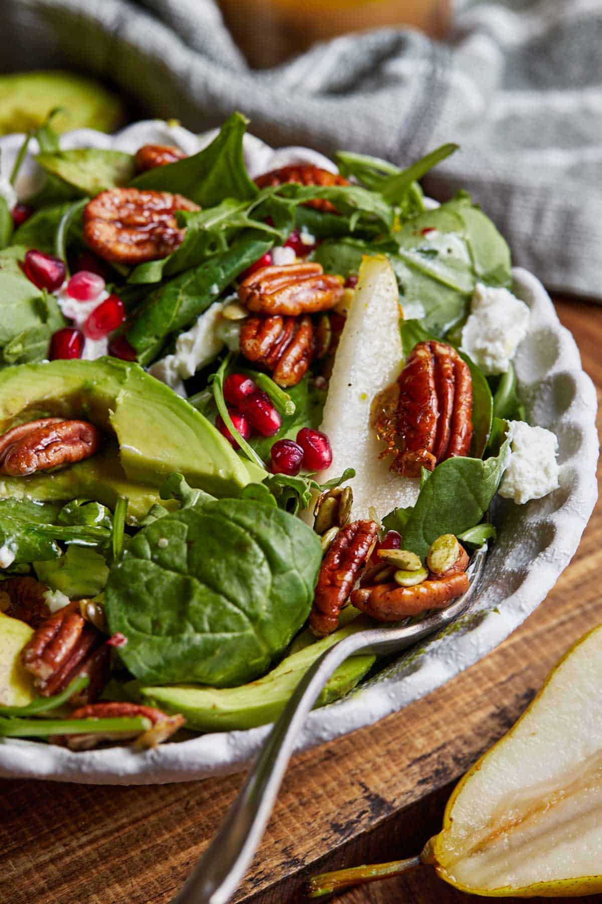 Pear and pomegranate salad with pecans and pomegranate vinaigrette.