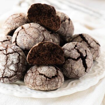 Chocolate Snowball cookies on a white plate.
