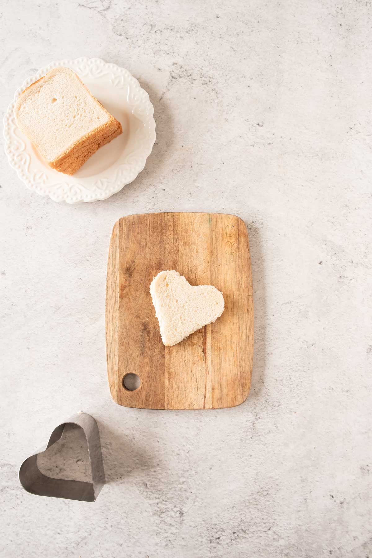 Heart shaped bread on a cutting board.