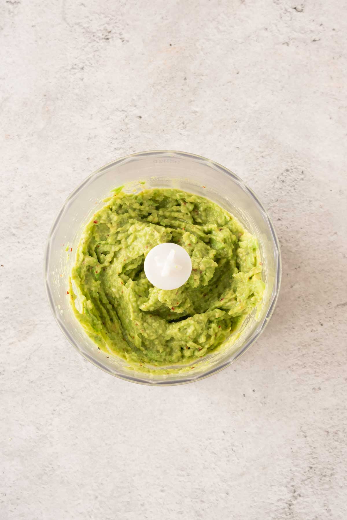 Mashed avocado in a food processor.