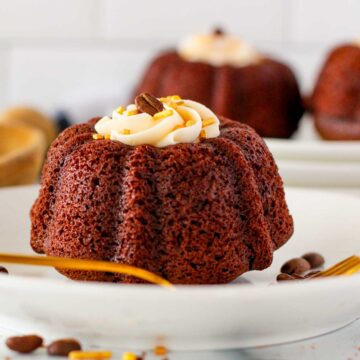 Mini coffee and Baileys bundt cake on a plate with a gold fork.