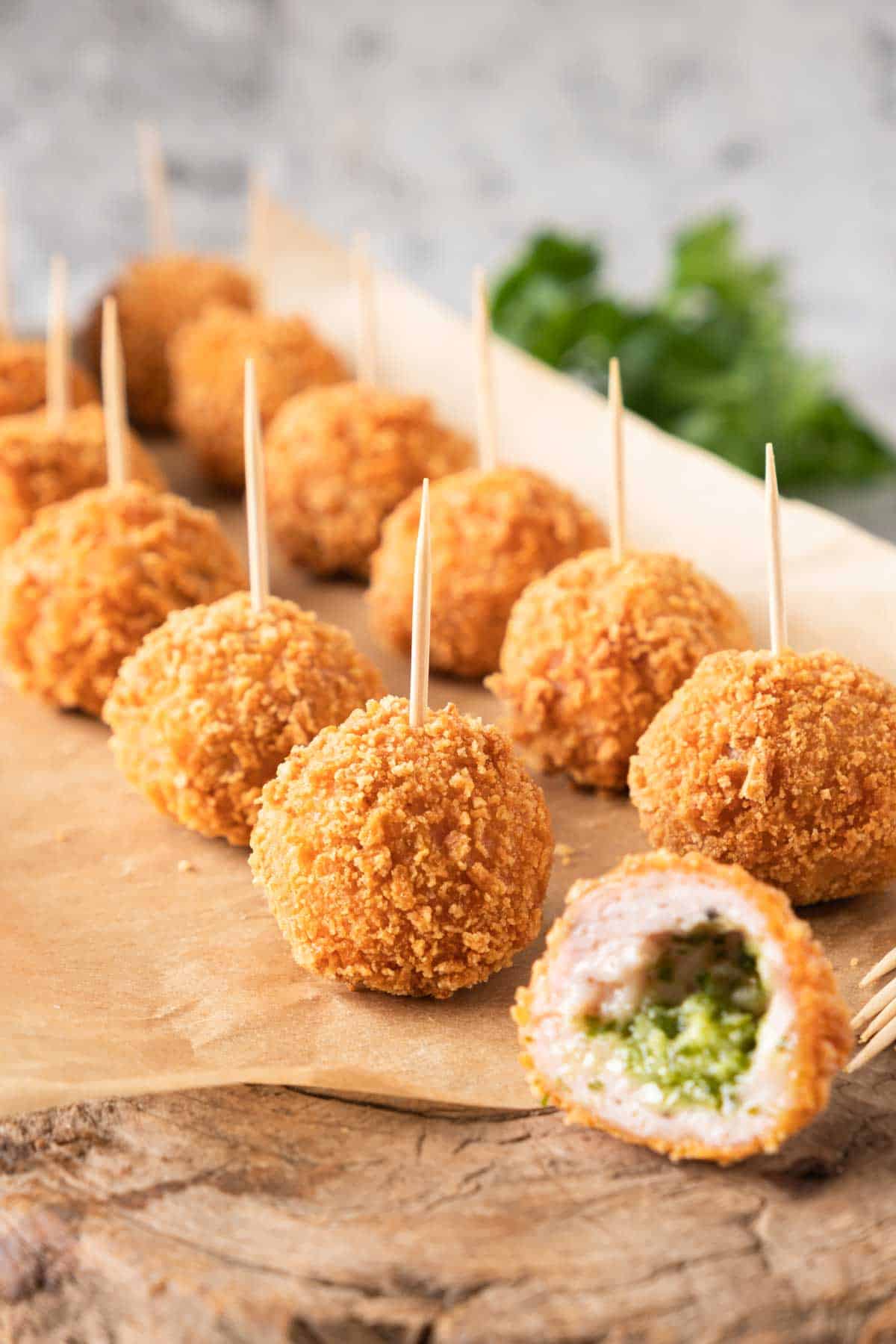 Chicken meatballs on toothpicks on a piece of paper.