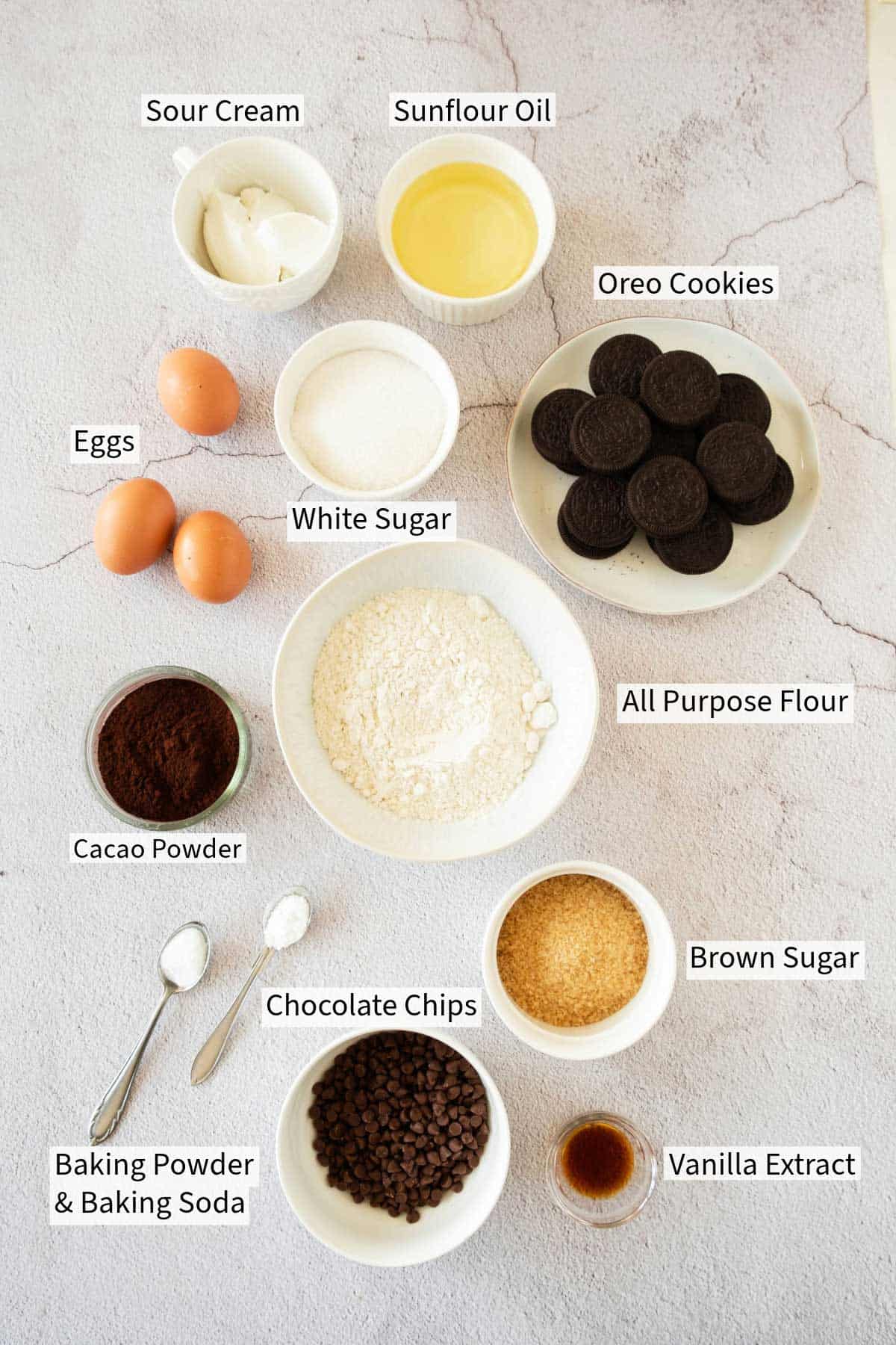 Various baking ingredients neatly arranged and labeled on a kitchen surface.