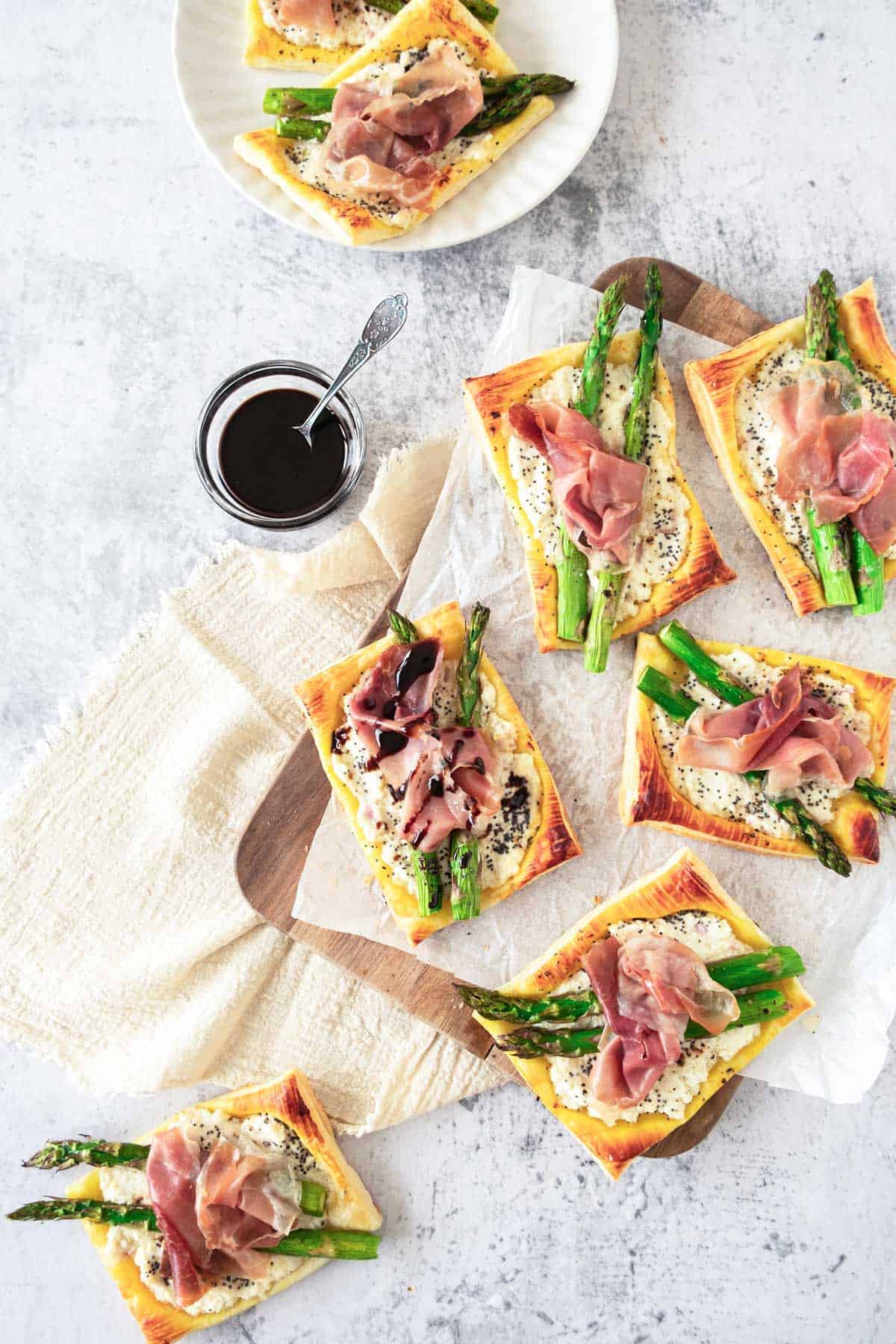 Ricotta, Asparagus and prosciutto tartlets served with balsamic glaze.