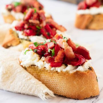 Ricotta Bruschetta topped with roasted red peppers and bacon.