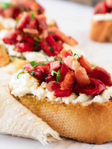 Ricotta Bruschetta topped with roasted red peppers and bacon.