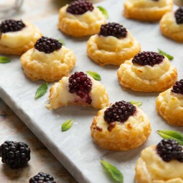 Puff pastry tarts topped with blackberries.