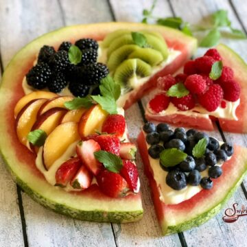 Watermelon pizza topped with summer fruits.